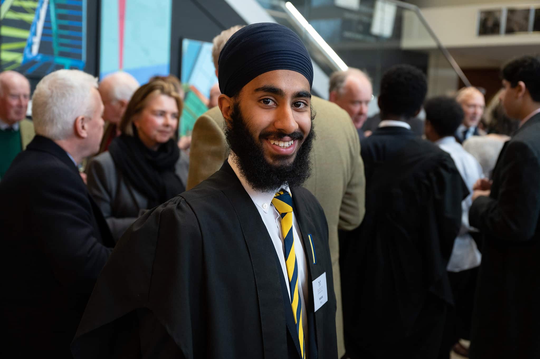 Boy smiling at the camera whilst wearing Radley College uniform