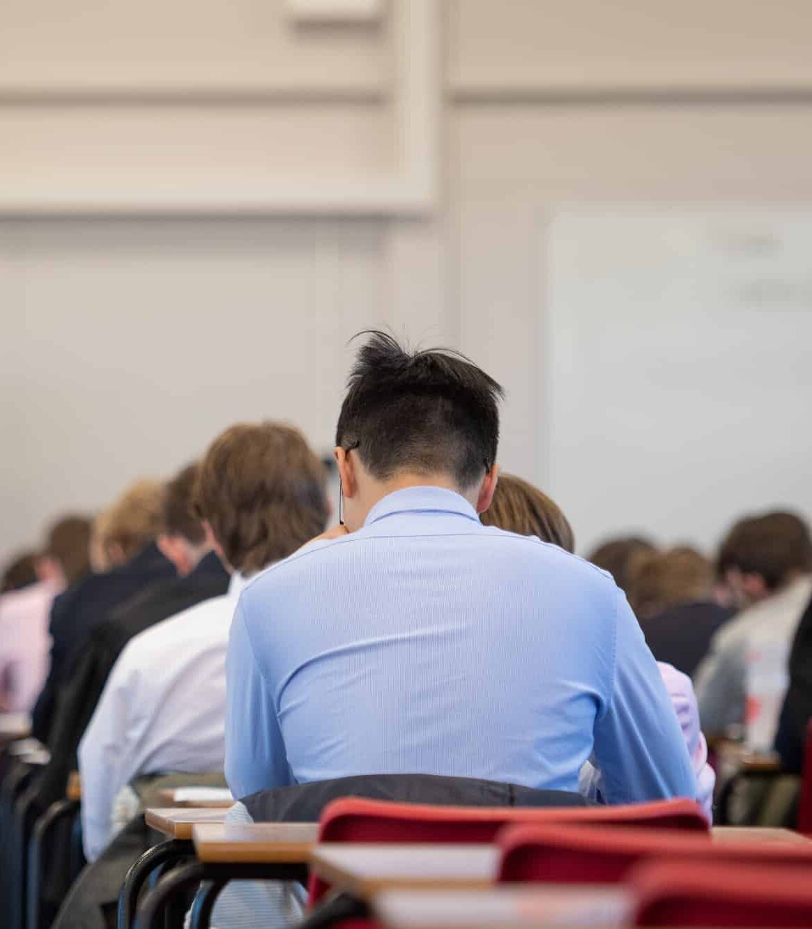 Back of a boy's head as he sits an examination